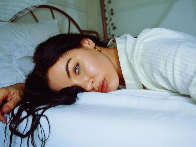 Person doing gentle face and eye exercises in morning light